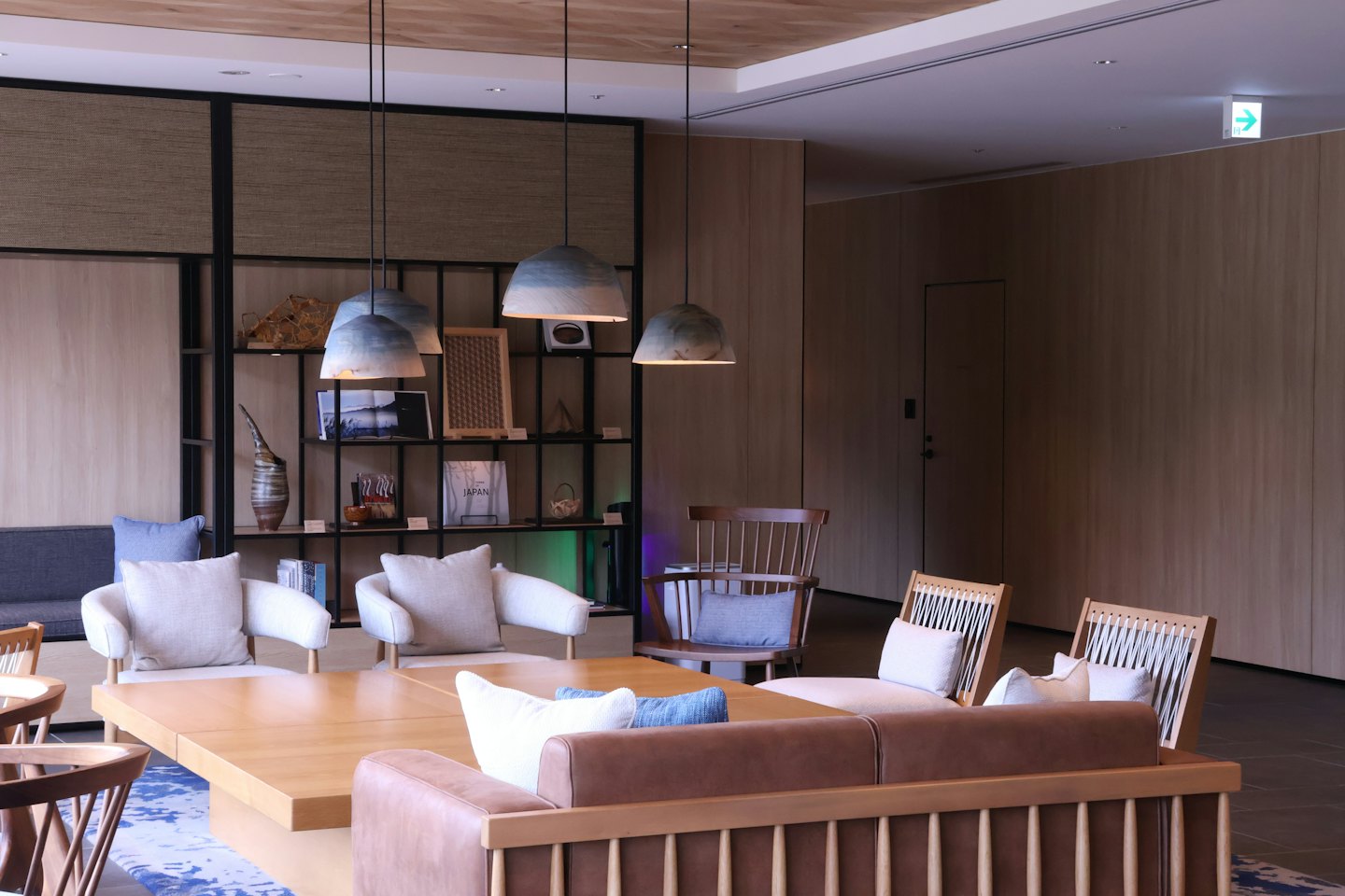 Modern lounge area with wooden tables and leather sofas.